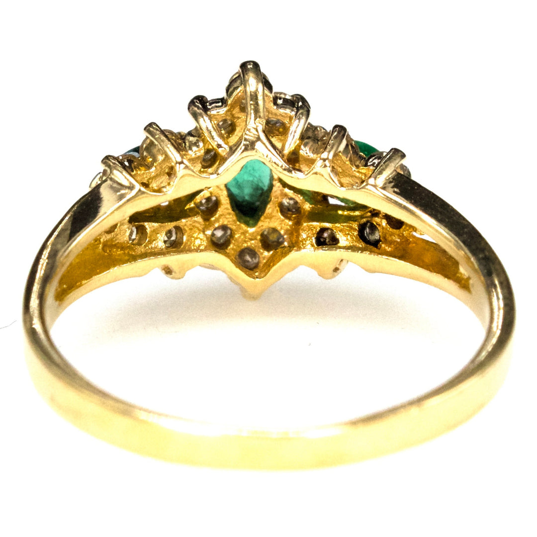 Vintage Three Stone Marquise Cut Emerald Ring with Diamond Surround in Gold