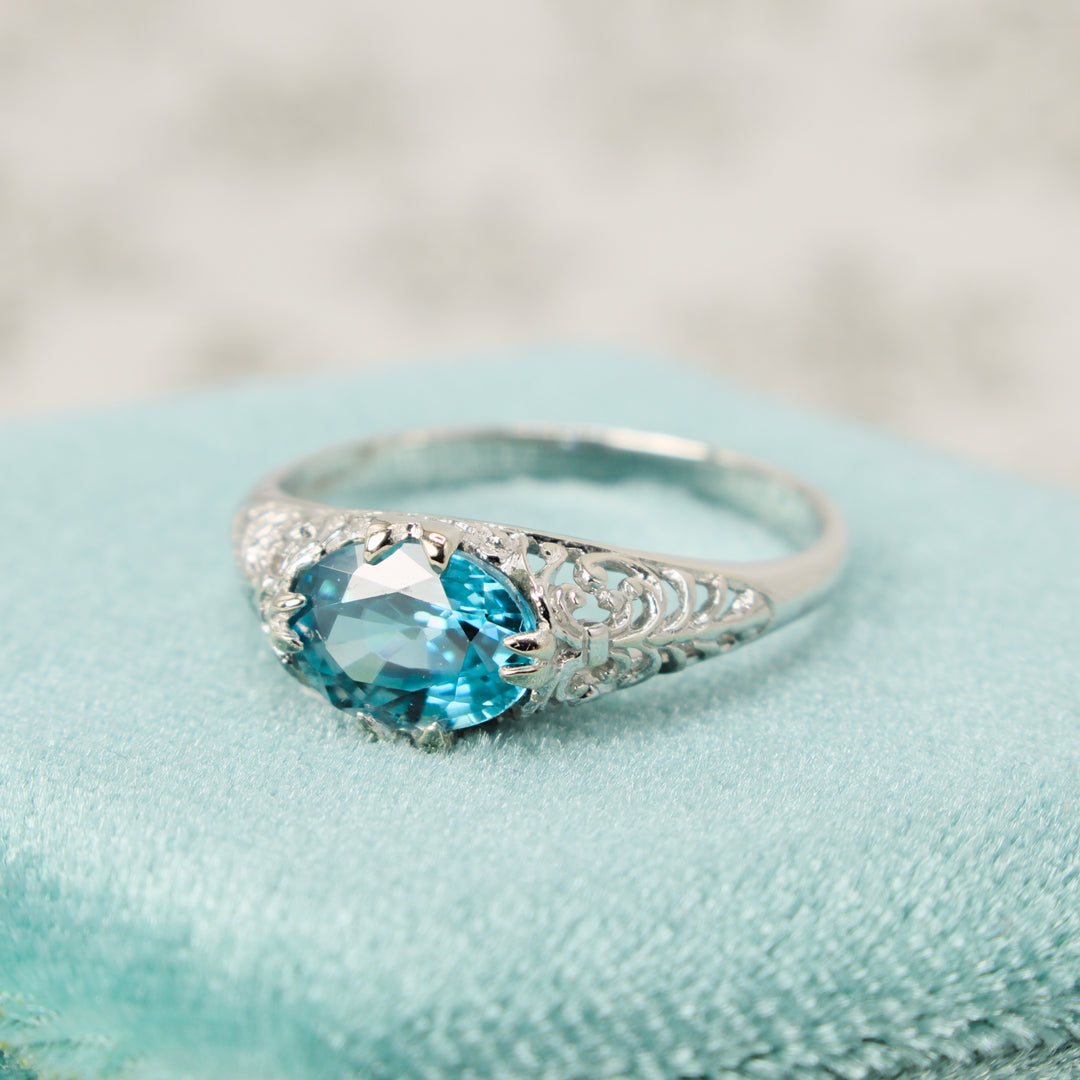 Art Deco Style Filigree Ring in 14K White Gold with Oval Blue Zircon Set East-West