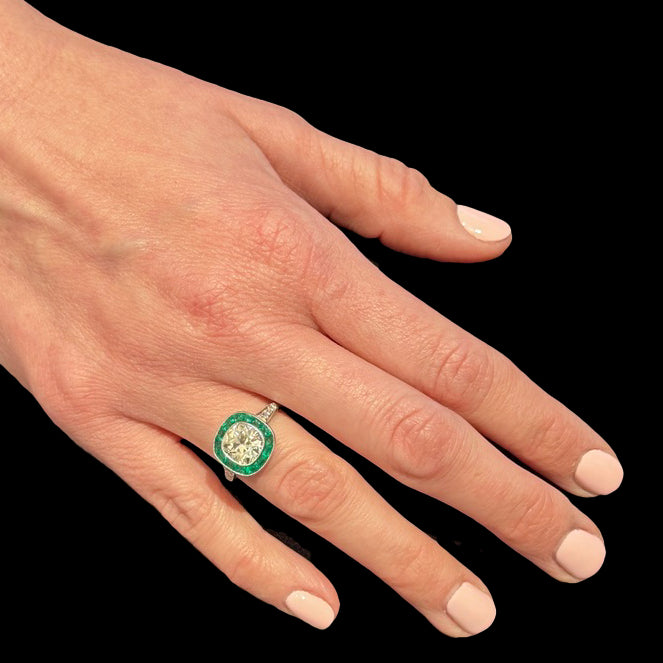 Platinum Art Deco Style Solitaire with 2.76 Carat Antique Cushion Cut Diamond and Emerald Halo