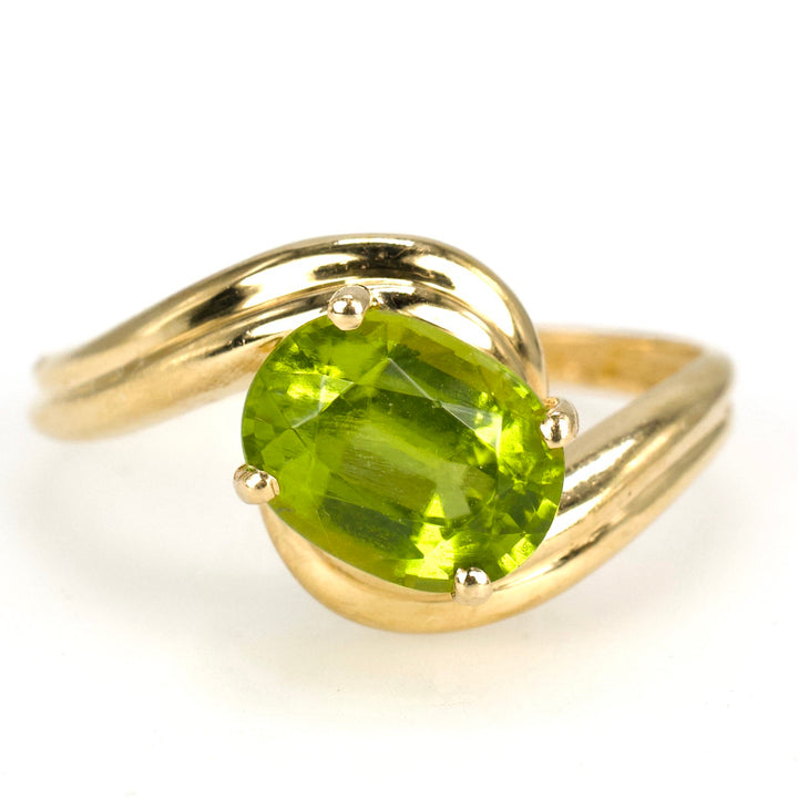 Diagonally Set Oval Peridot Bypass Style Solitaire in Gold