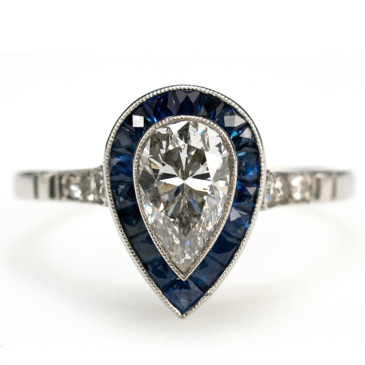 Art Deco Style Platinum Ring with 0.69 Carat Pear Cut Diamond and Sapphire Halo