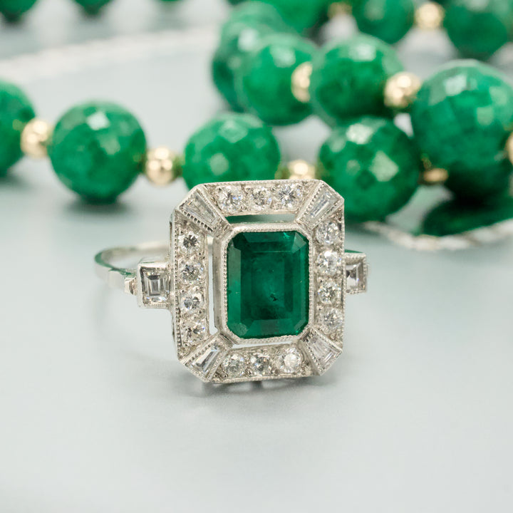 Estate 1.40 Carat Emerald Cut Emerald in Art Deco Style White Gold Setting with Diamond Halo