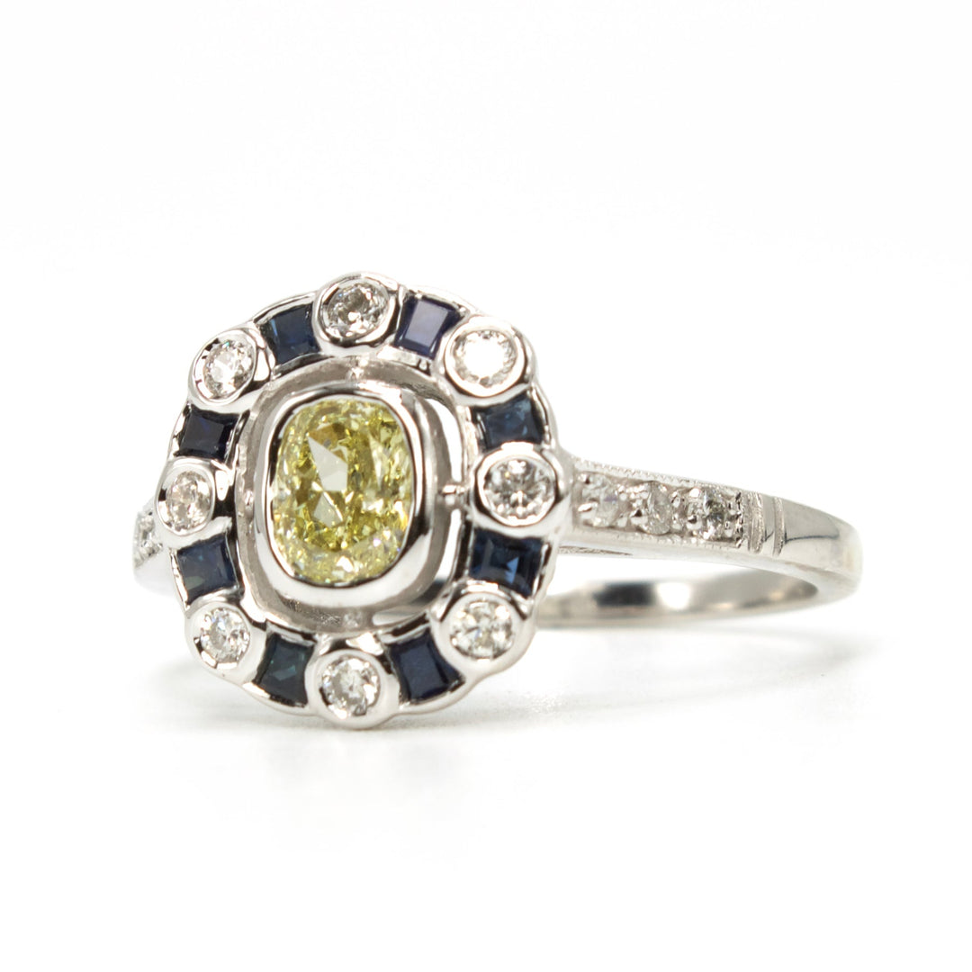 Fancy Yellow Cushion Cut Diamond with Diamond and Sapphire Halo
