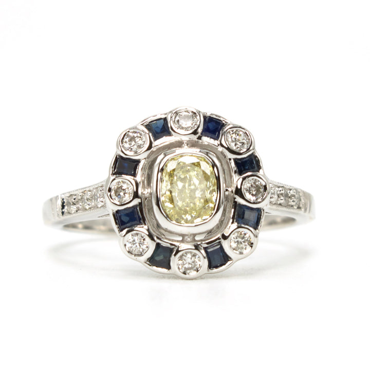 Fancy Yellow Cushion Cut Diamond with Diamond and Sapphire Halo