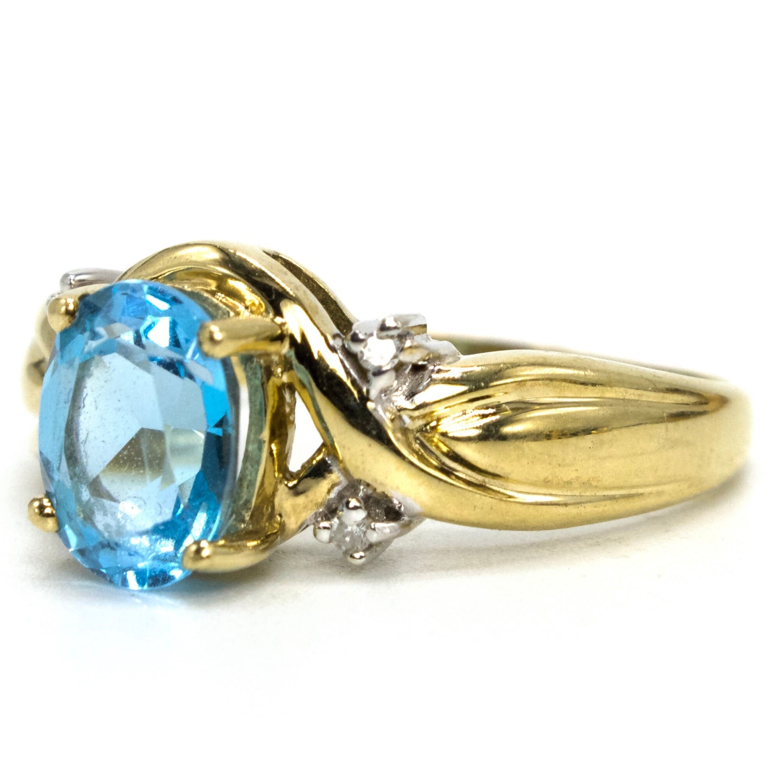 Criss Cross Gold Ring with Oval Blue Topaz and Accent Diamonds