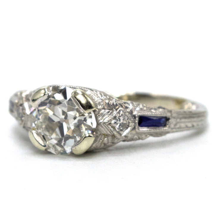 Art Deco Platinum and 1.00 Carat European Cut Diamond Filigreed Engagement Ring with Sapphire Baguette Accents