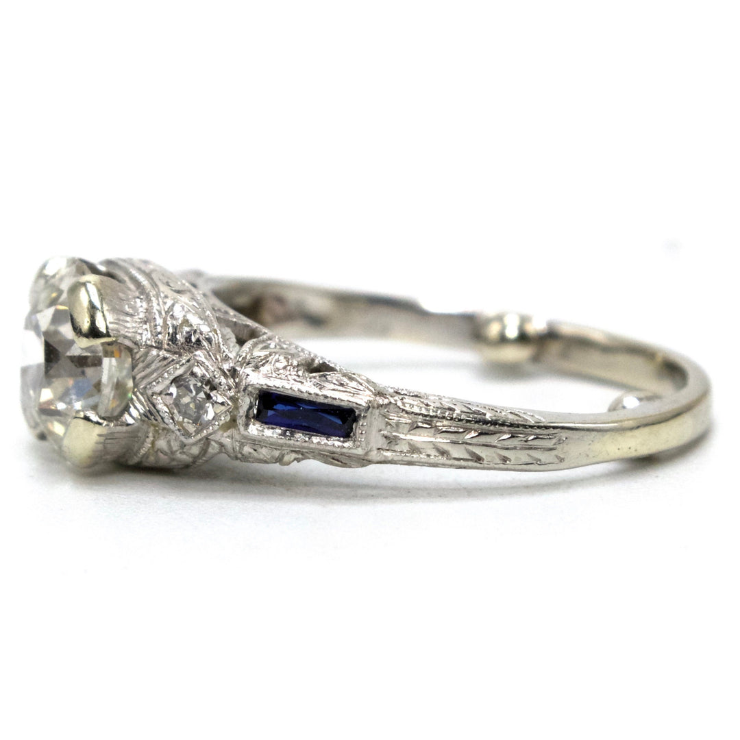 Art Deco Platinum and 1.00 Carat European Cut Diamond Filigreed Engagement Ring with Sapphire Baguette Accents