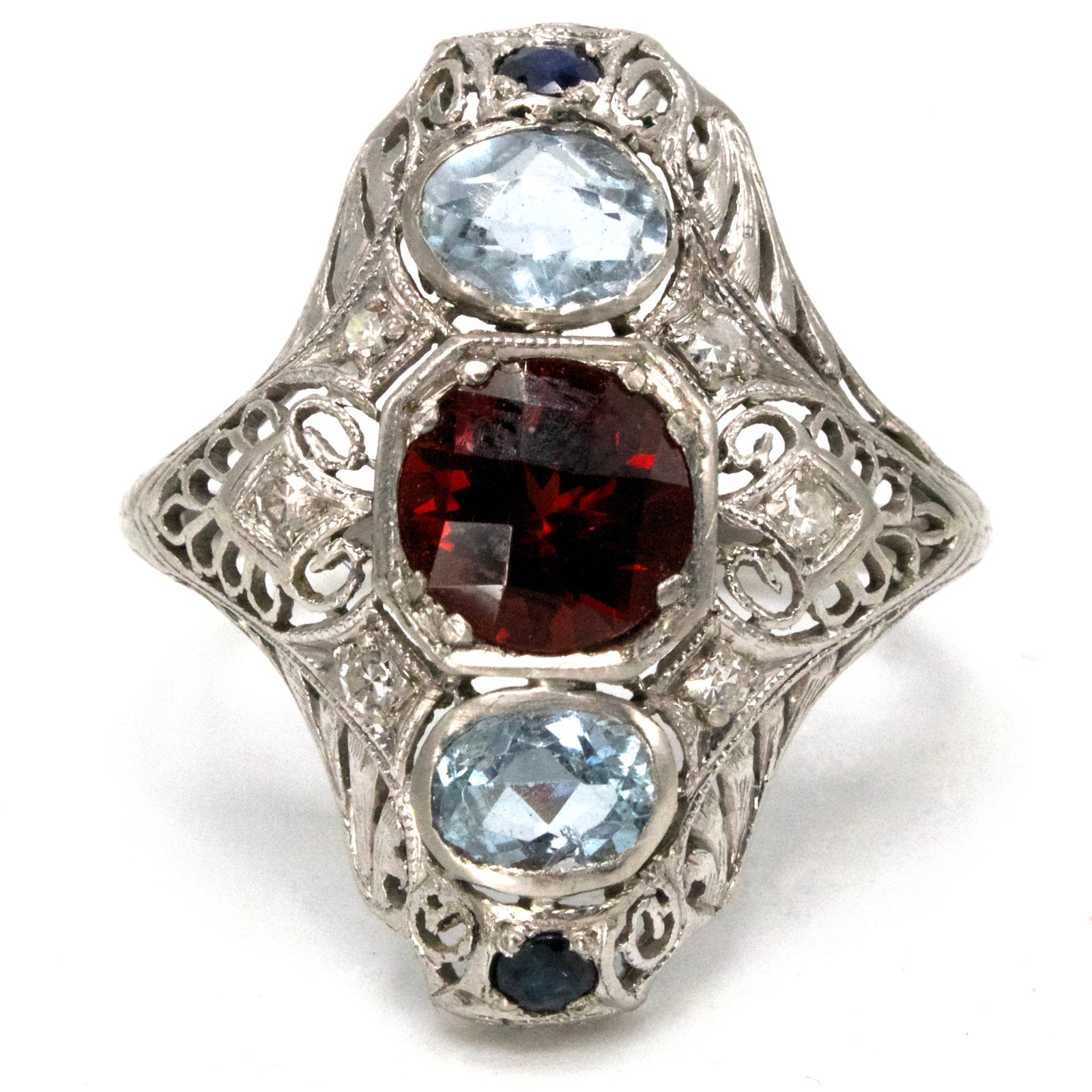 Elongated Edwardian Platinum Ring with Garnet, Aquamarines, Sapphires, and Diamonds