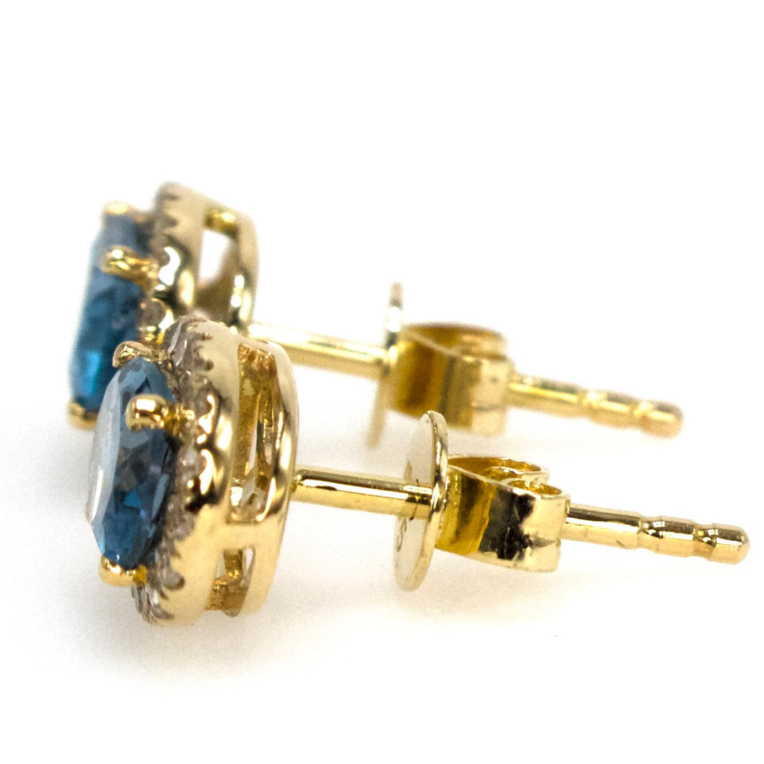 Oval London Blue Topaz Stud Earrings with Diamond Halo in Yellow Gold