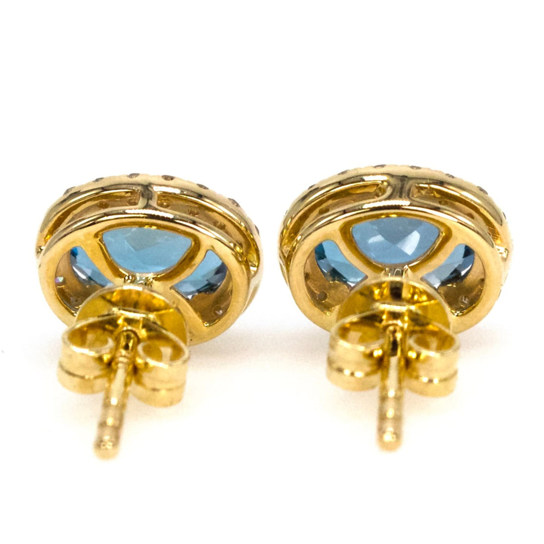 Oval London Blue Topaz Stud Earrings with Diamond Halo in Yellow Gold