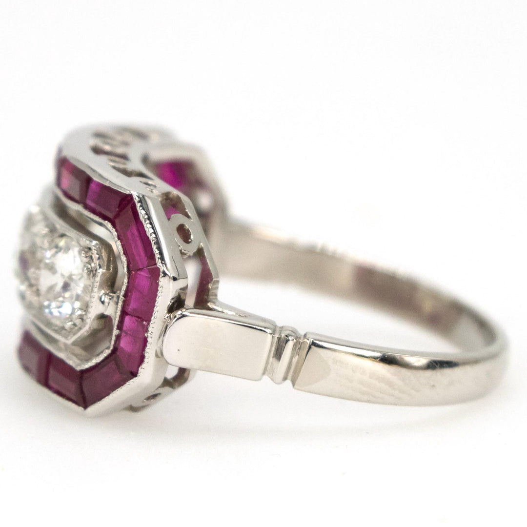 Art Deco Style Four Diamond Ring with Calibre Cut Ruby Surround in Platinum