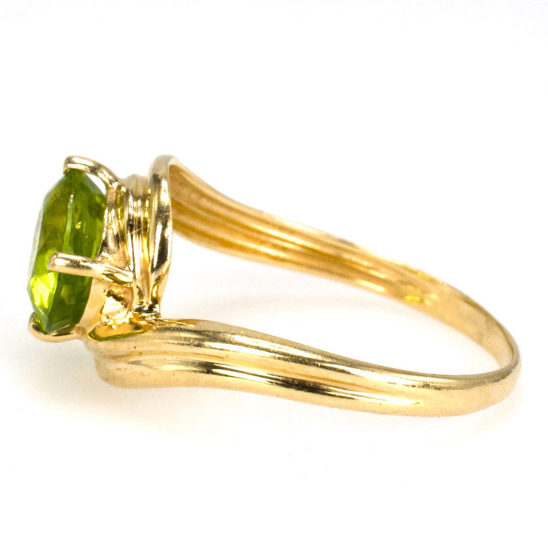 Diagonally Set Oval Peridot Bypass Style Solitaire in Gold