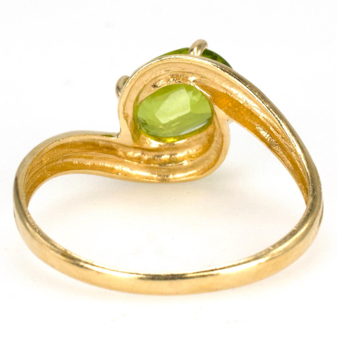 Diagonally Set Oval Peridot Bypass Style Solitaire in Gold