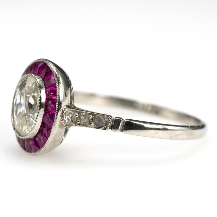 Art Deco Platinum Ring with 0.75 Carat Antique Oval Cut Diamond and Ruby Halo