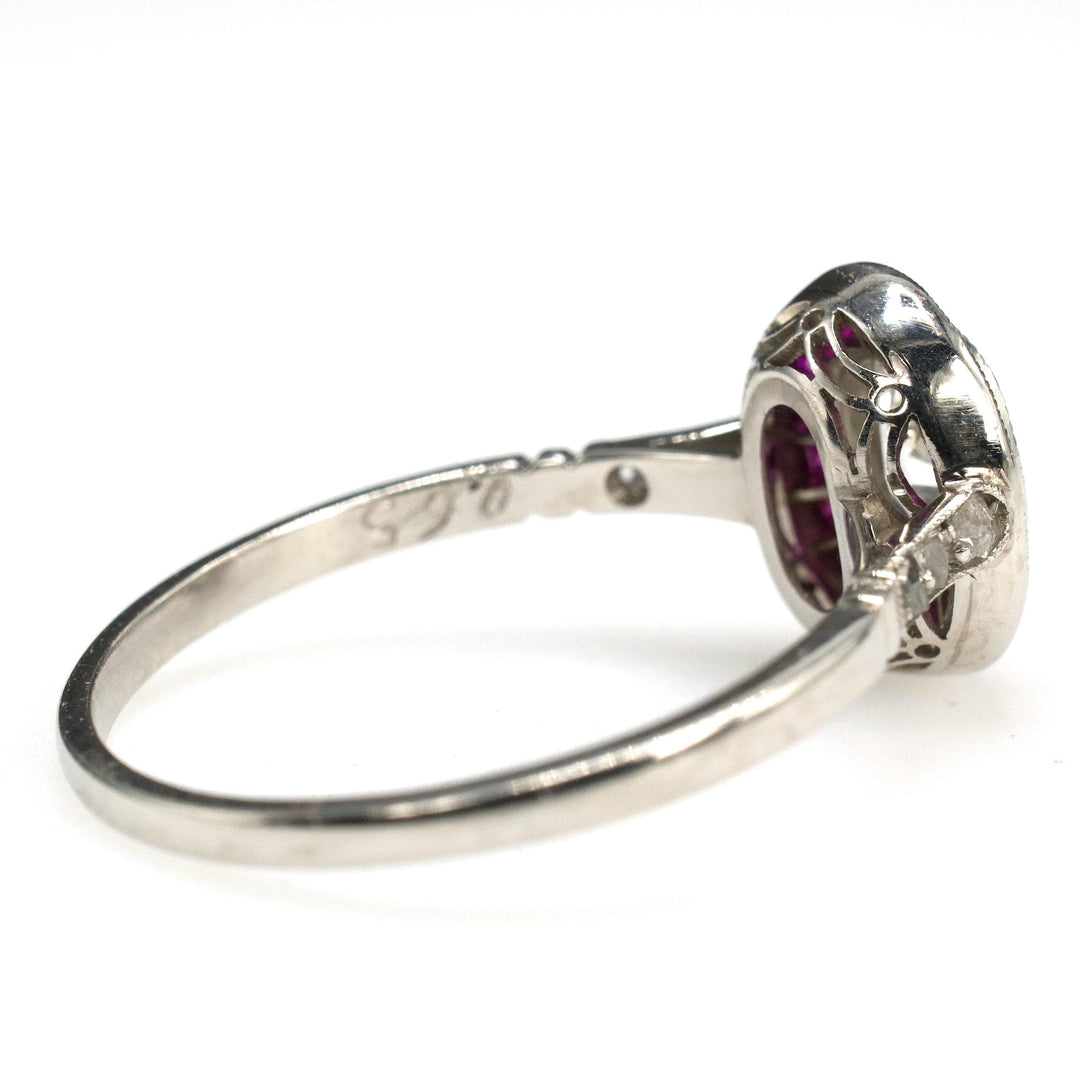 Art Deco Platinum Ring with 0.75 Carat Antique Oval Cut Diamond and Ruby Halo