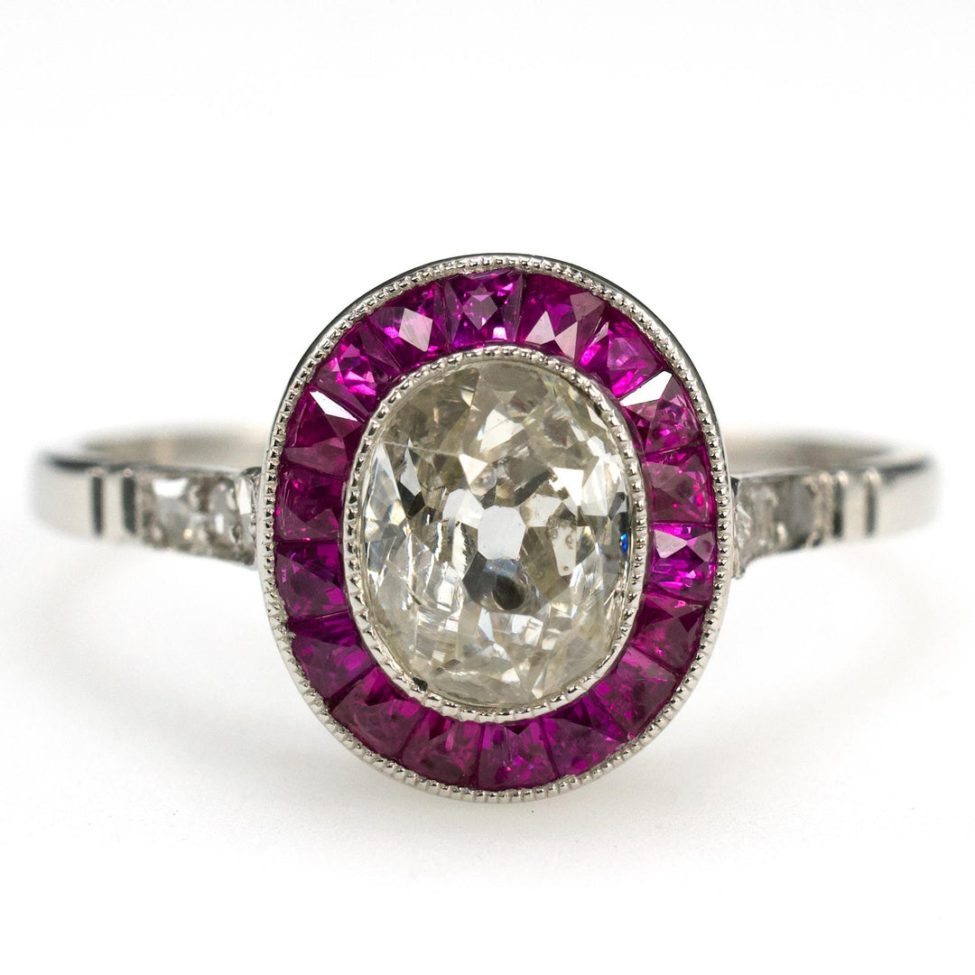 Art Deco Platinum Ring with 0.75 Carat Antique Oval Cut Diamond and Ruby Halo