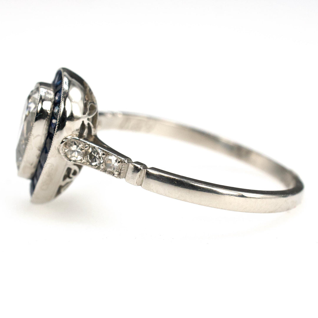 Art Deco Style Platinum Ring with 0.69 Carat Pear Cut Diamond and Sapphire Halo