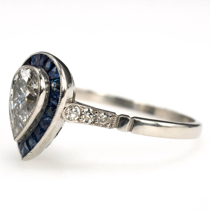 Art Deco Style Platinum Ring with 0.69 Carat Pear Cut Diamond and Sapphire Halo