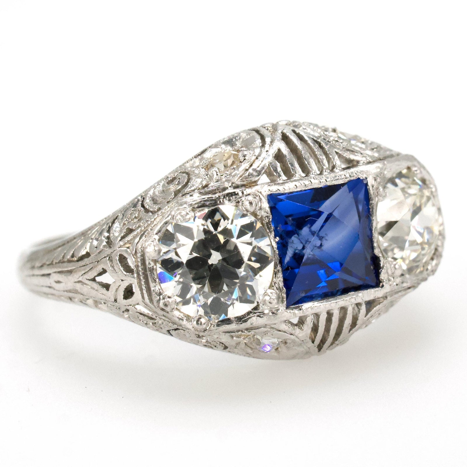 Edwardian Three Stone Platinum Filigree Ring with European Cut Diamonds and French Cut Sapphire