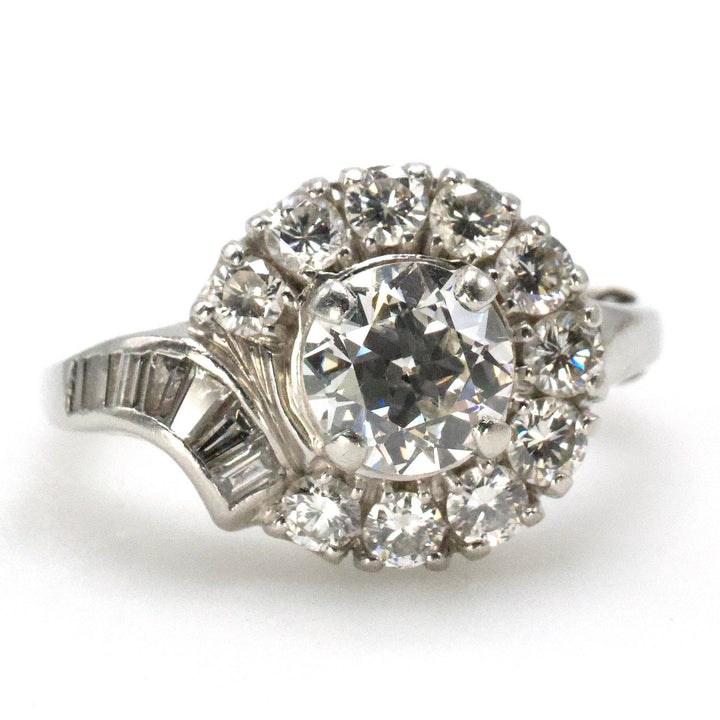 Midcentury Asymmetric Round Brilliant Diamond Ring with Partial Halo and Accent Baguettes