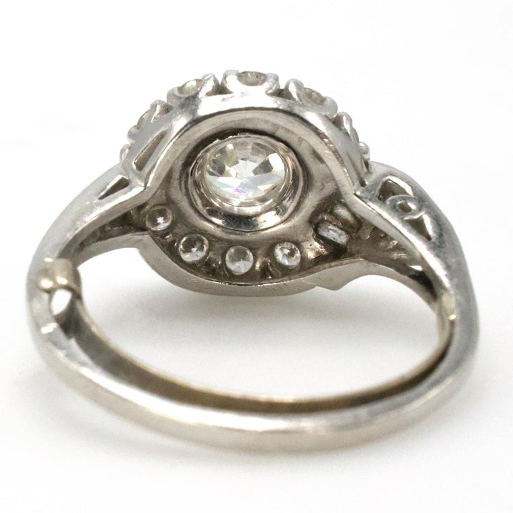 Midcentury Asymmetric Round Brilliant Diamond Ring with Partial Halo and Accent Baguettes