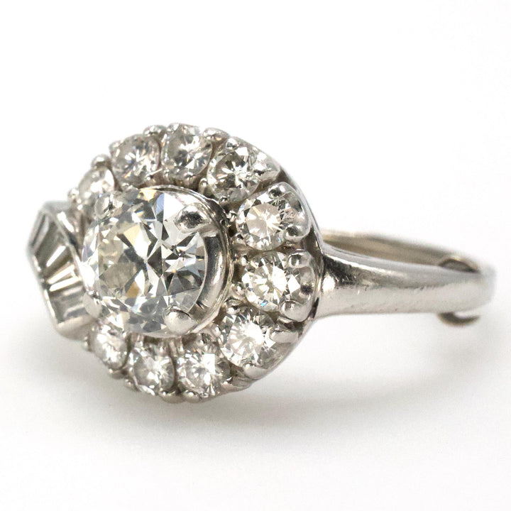 Midcentury Asymmetric Round Brilliant Diamond Ring with Partial Halo and Accent Baguettes