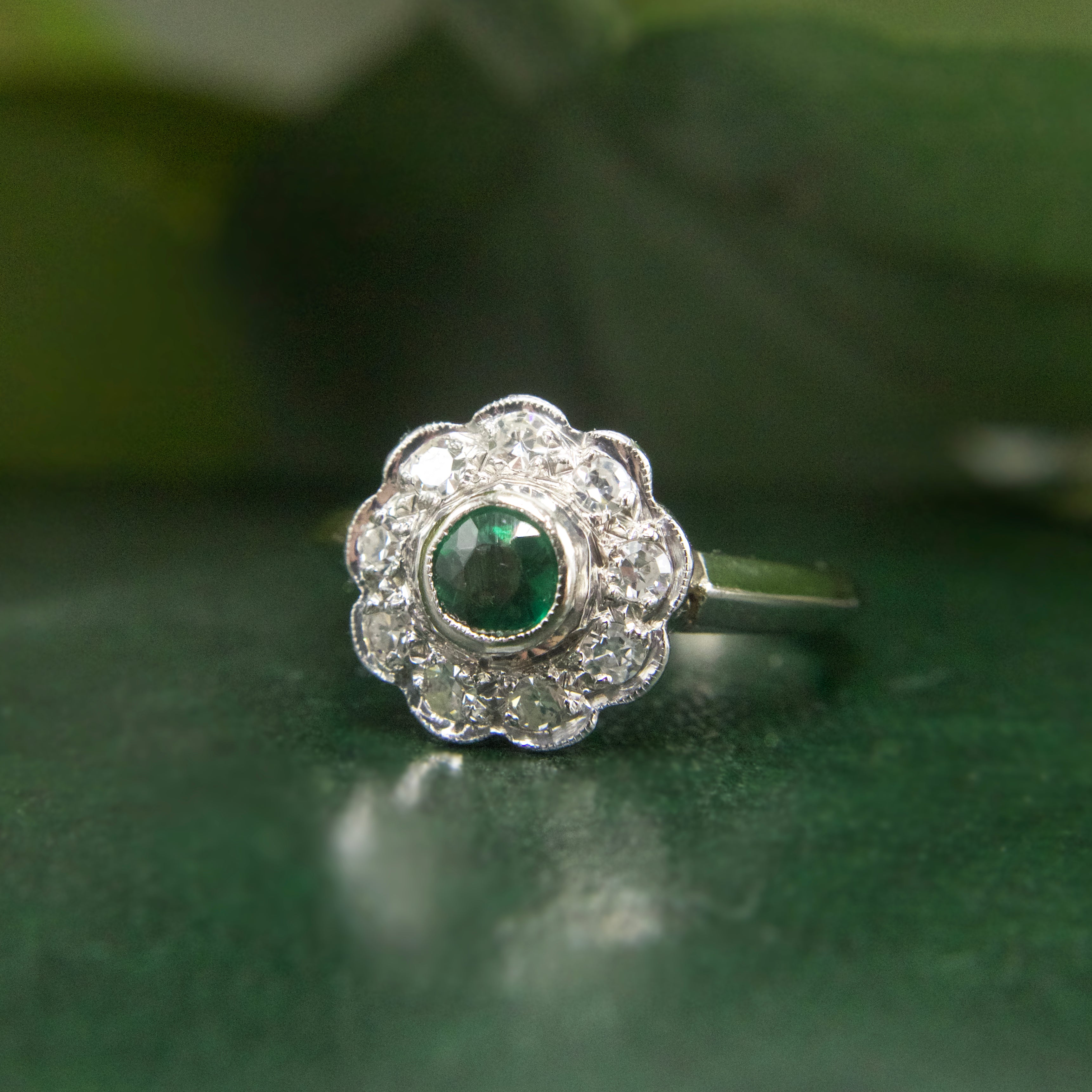 Vintage Emerald and Diamond Floral Halo Ring in Platinum