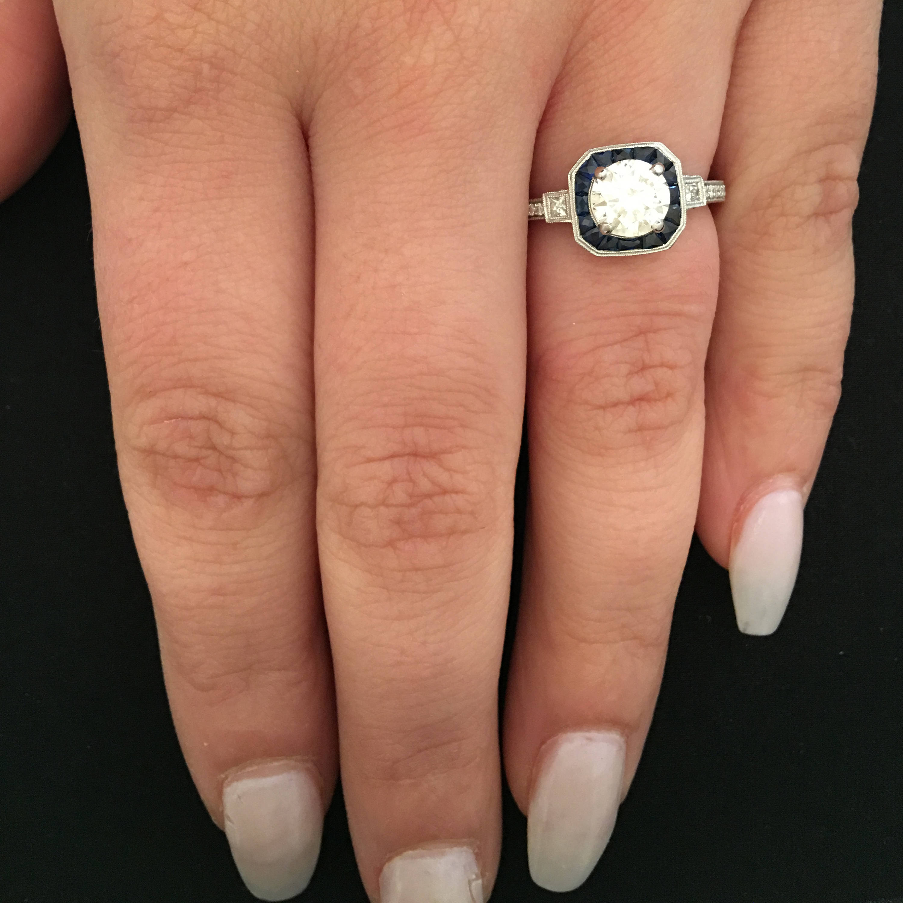Art Deco Style Light Carat Diamond Ring with Sapphire Halo in White Gold