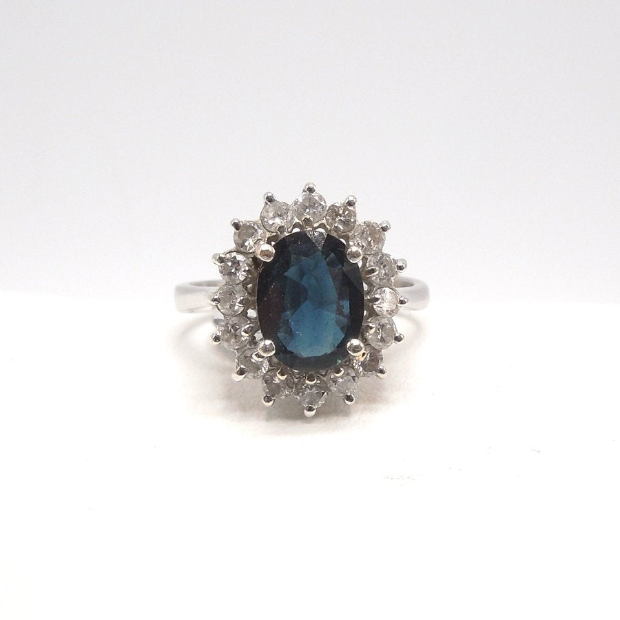 2+ct Deep Blue Sapphire in White Gold with a Surround of Diamonds
