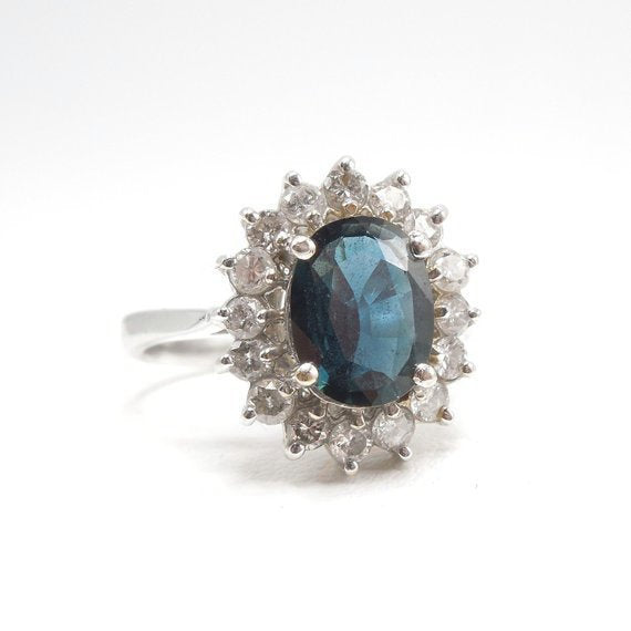2+ct Deep Blue Sapphire in White Gold with a Surround of Diamonds