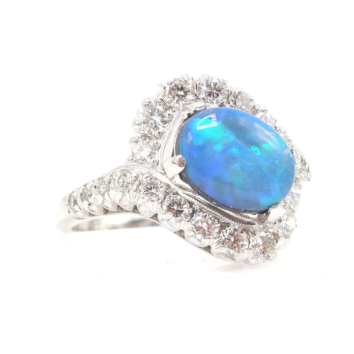 Oval Black Opal Surrounded by a Swirl of Diamonds in White Gold