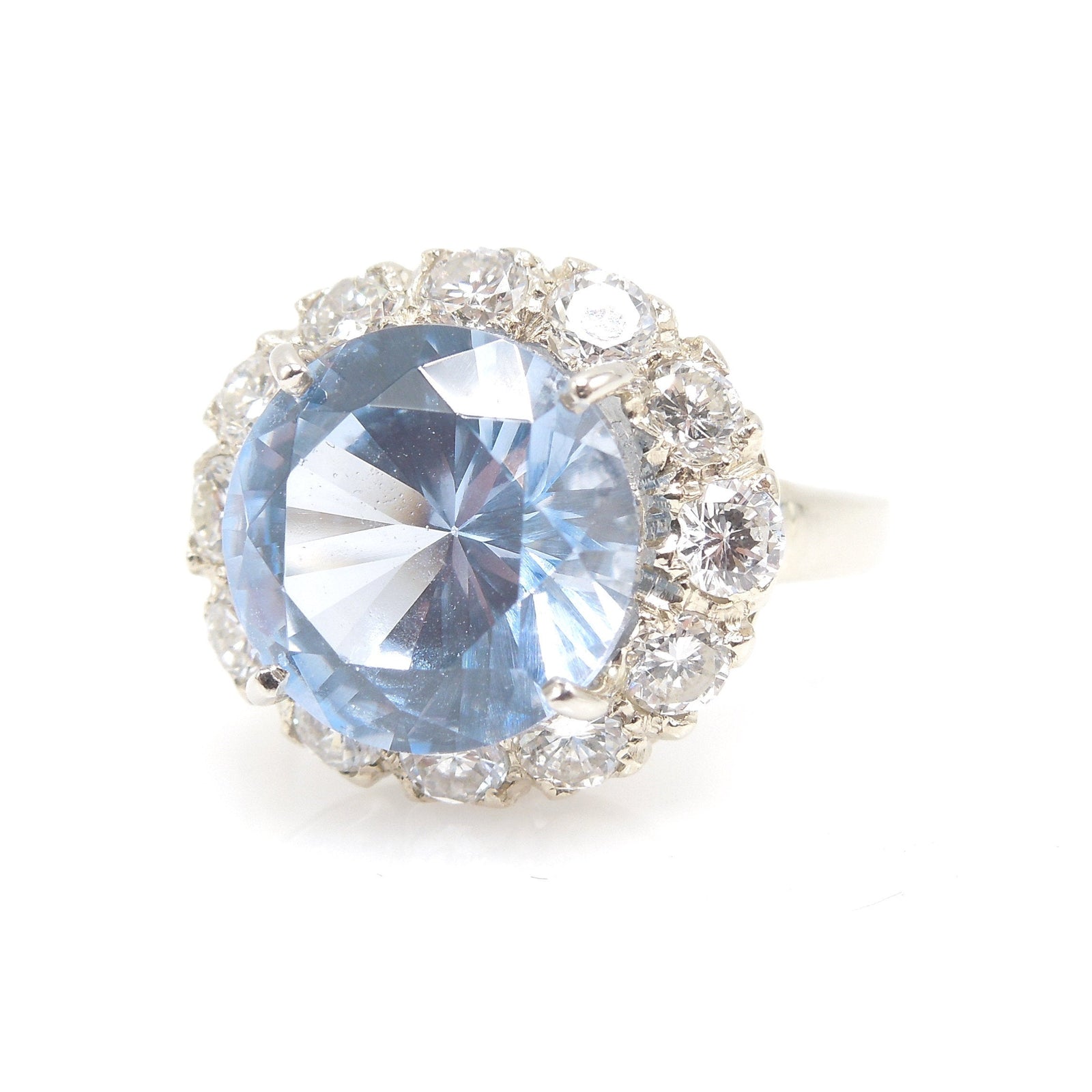 Large Round Blue Spinel Ring Surrounded by Diamond Halo in White Gold