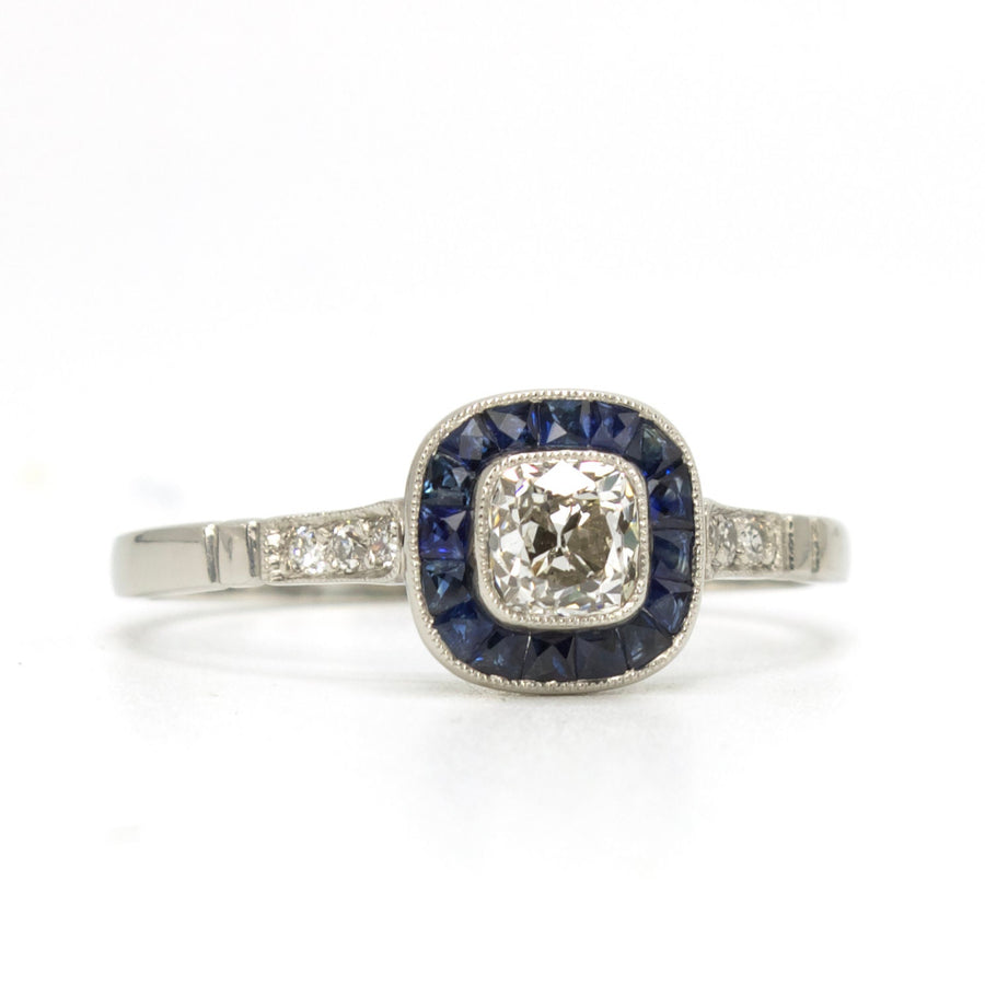 Antique Cushion Cut Diamond Target Ring with French Cut Sapphire Halo in Platinum