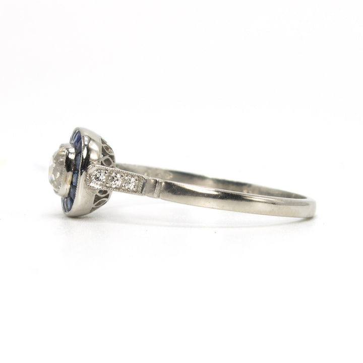 Antique Cushion Cut Diamond Target Ring with French Cut Sapphire Halo in Platinum