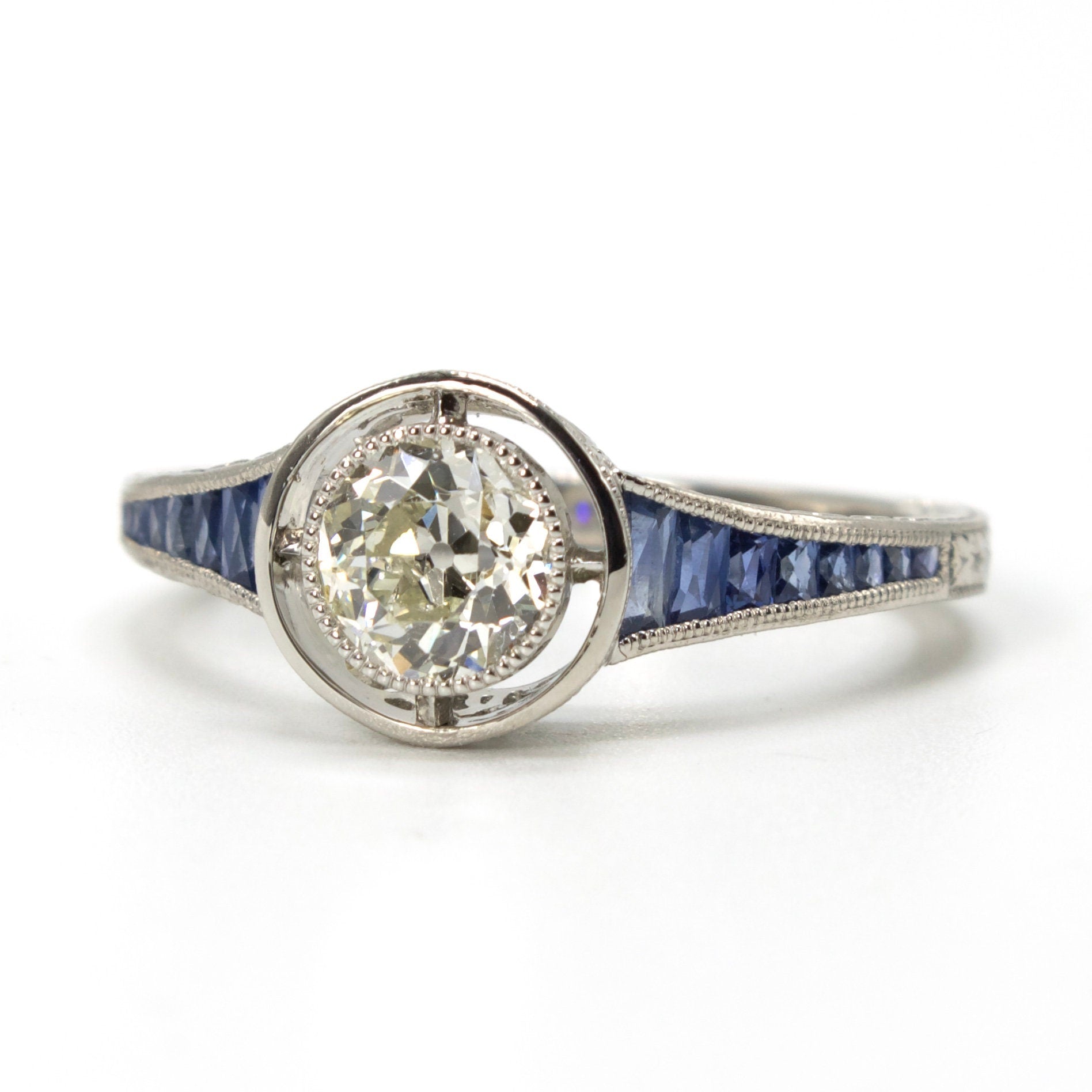 Art Deco Style Bezel Set 0.71 ct European Cut Diamond in Sapphire Accented Solitaire with Airline in Platinum