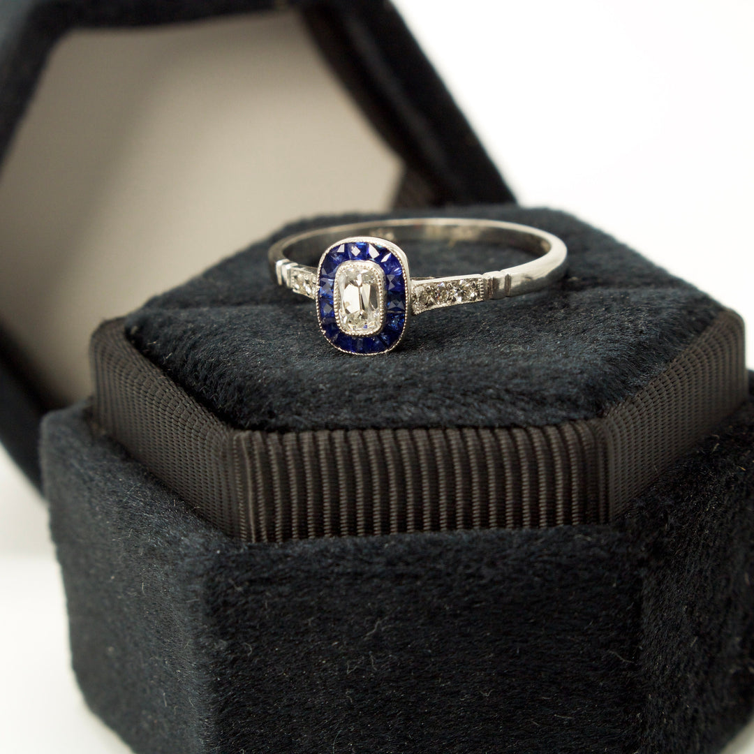 Rare and Unusual Antique Elongated Cushion Cut Diamond Target Ring with French Cut Sapphire Halo in Platinum